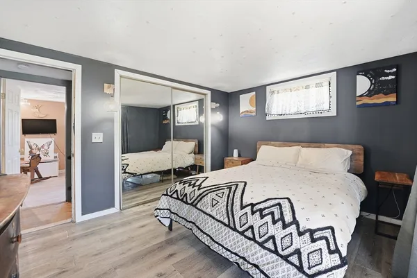a bedroom with a bed and a mirror