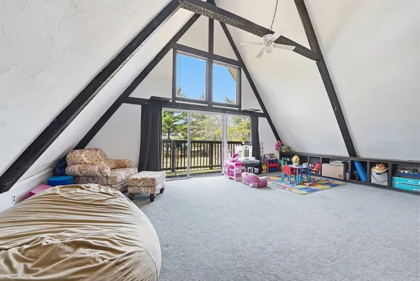 a bedroom with furniture and large windows