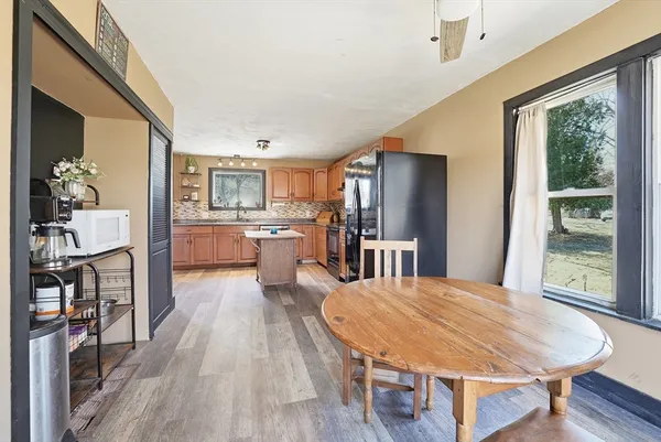 a large kitchen with a table and chairs