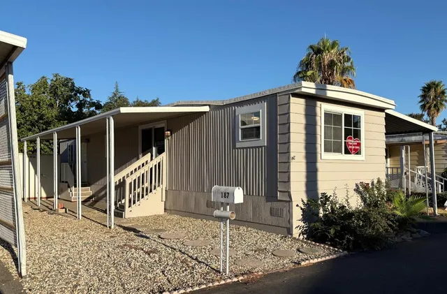 a front view of a house with plants
