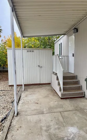 a view of a house with wooden fence