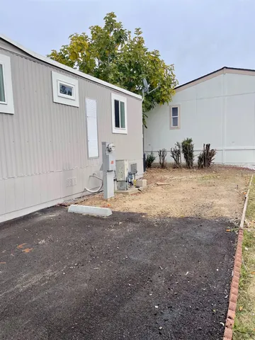 a front view of a house with plants