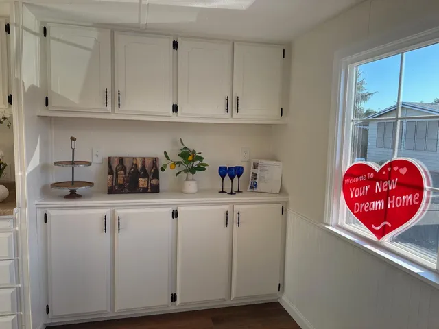 a kitchen with white cabinets and a sink