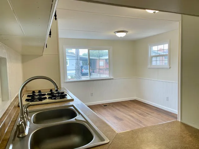 a kitchen with a stove and a window