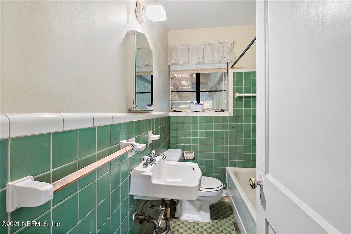 1951 Huntsford Road Jacksonville, FL 32207 - Photo 10 of 17 a bathroom with a sink toilet and a mirror