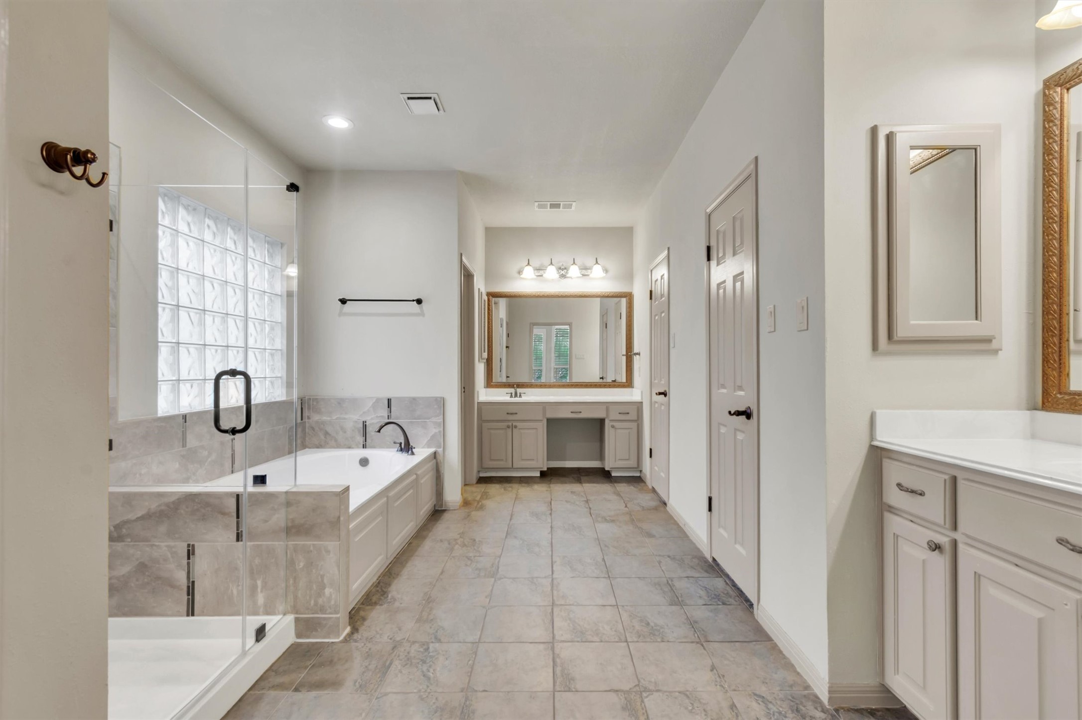 6008 Tributary Ridge Court Austin, TX 78759 - Photo 13 of 36 A spacious primary bath featuring a soaking tub, separate shower, and dual vanities.