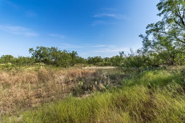 a view of lake with green space