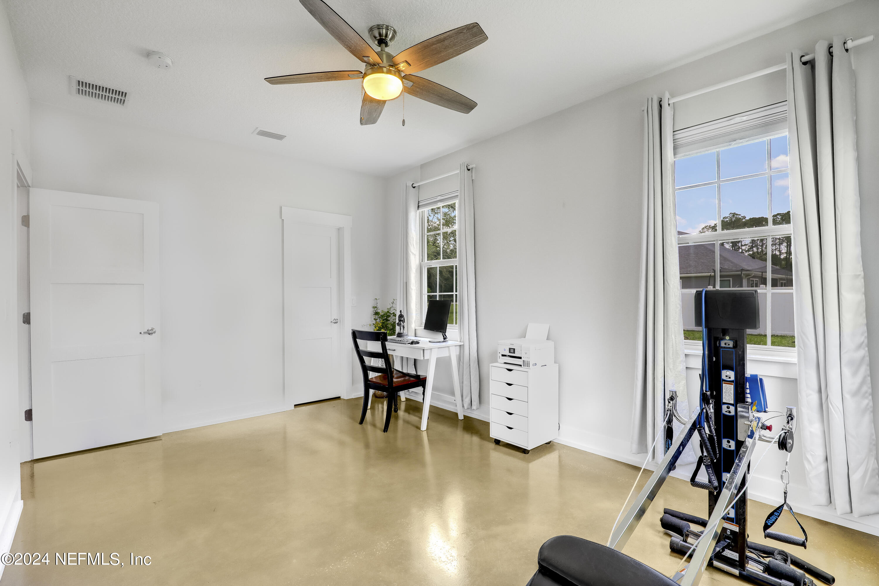540685 Lem Turner Road Callahan, FL 32011 - Photo 28 of 58 a view of a livingroom with furniture and gym equipment