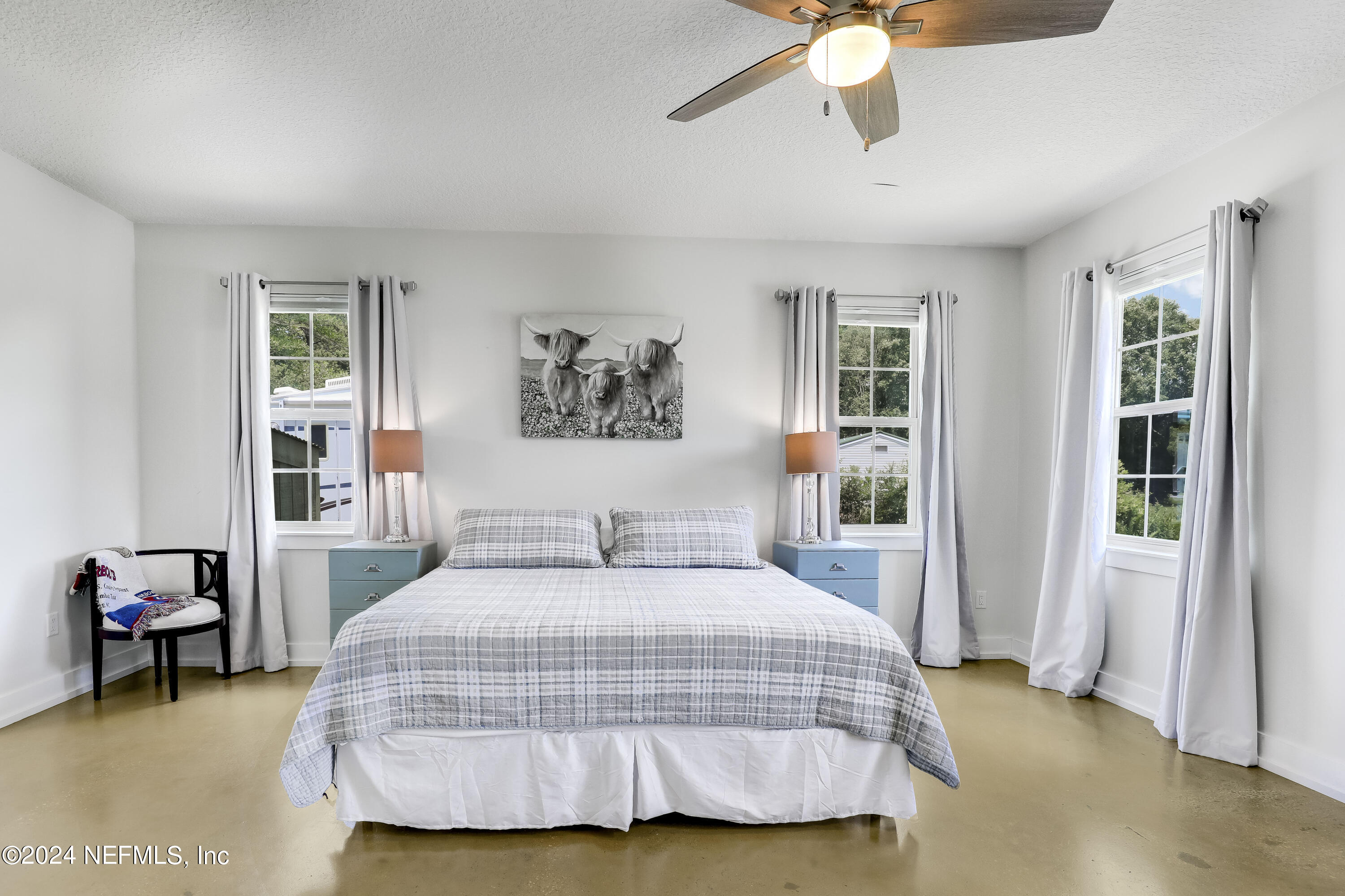540685 Lem Turner Road Callahan, FL 32011 - Photo 4 of 58 a bedroom with a bed and a chandelier