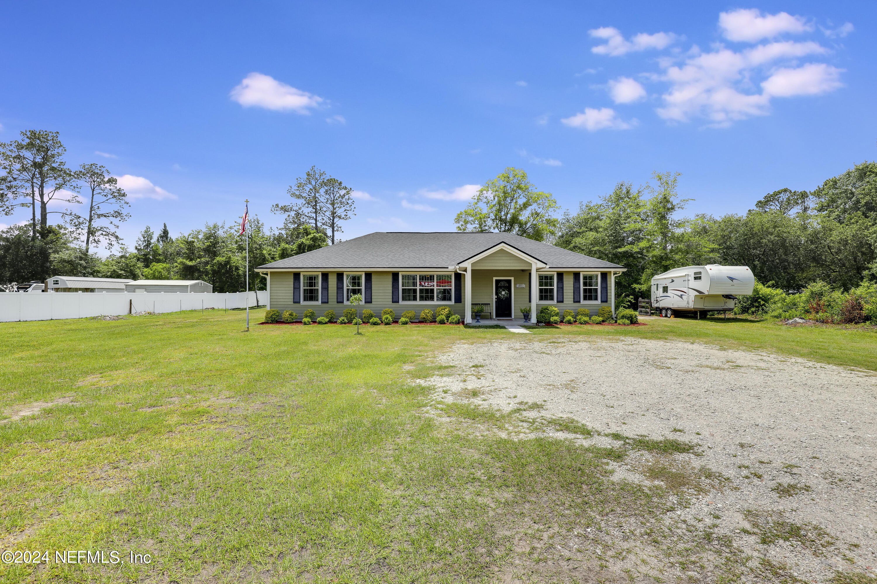 540685 Lem Turner Road Callahan, FL 32011 - Photo 46 of 58 a front view of a house with garden