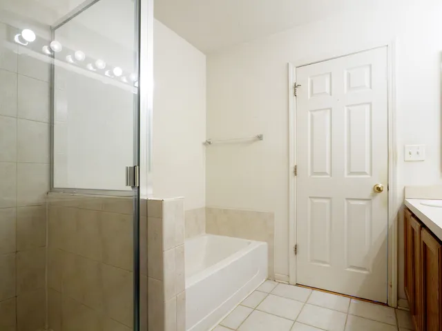 a bathroom with a bathtub and a shower