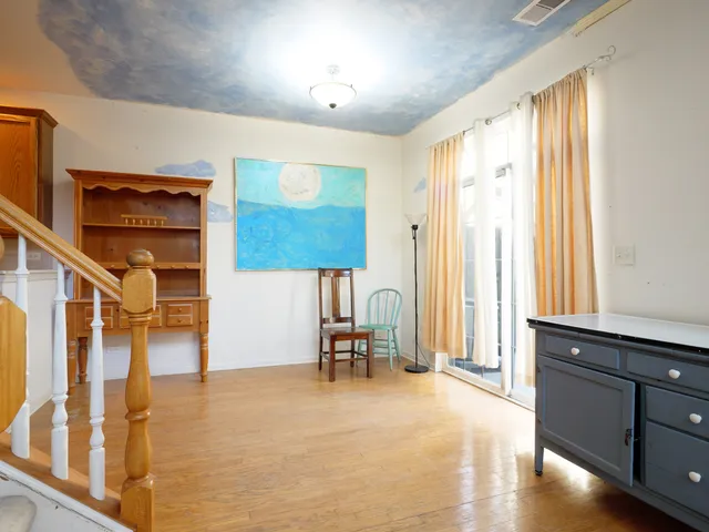 a dining room with furniture and a window