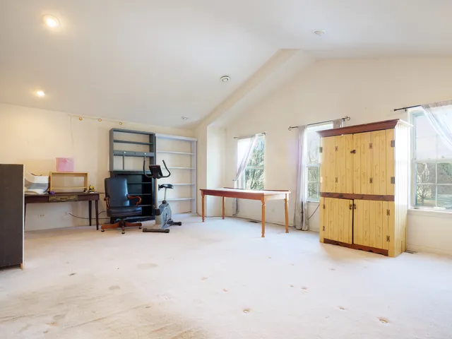 a view of kitchen with furniture and a refrigerator