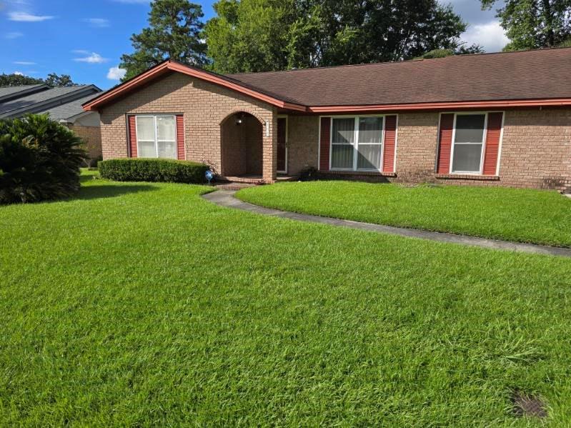 208 Leeds Gate Road Savannah, GA 31406 - Photo 1 of 1 a front view of a house with yard and green space