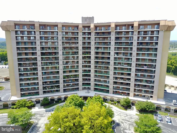 a front view of a building with a garden