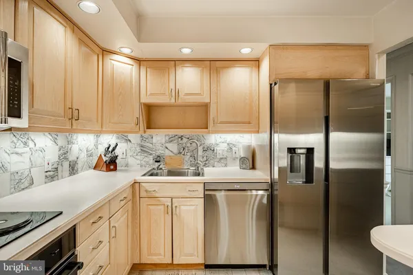 a kitchen with a sink cabinets and refrigerator