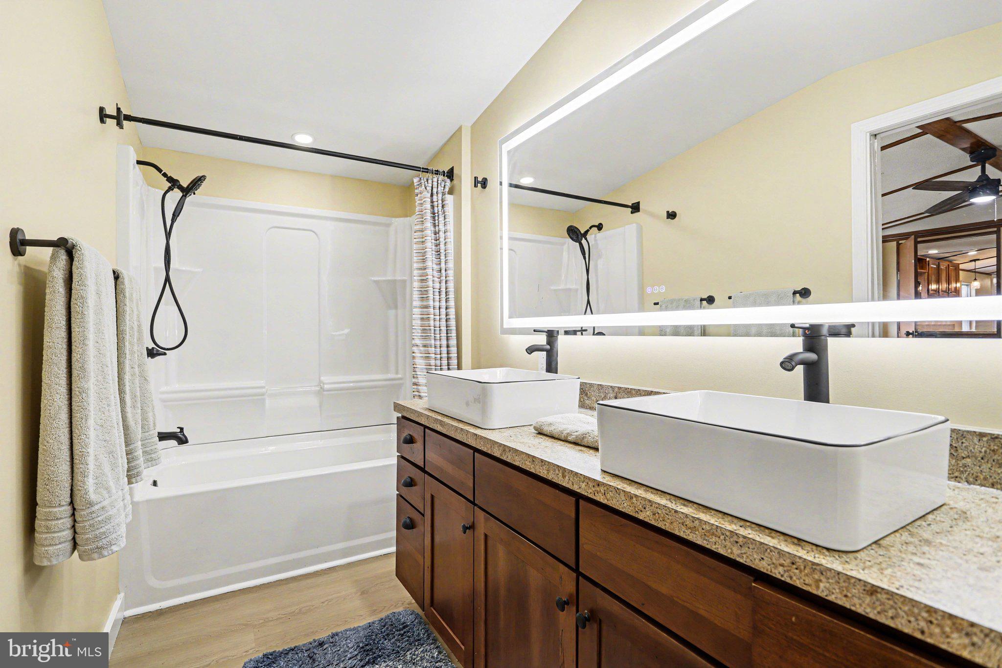 31 Davis Avenue Gettysburg, PA 17325 - Photo 21 of 27 a bathroom with a granite countertop sink mirror and a bathtub