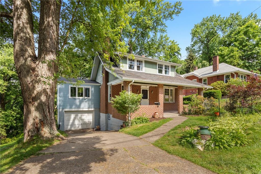 9 Woodside Road Pittsburgh, PA 15221 - Photo 1 of 24 a front view of a house with a yard and potted plants