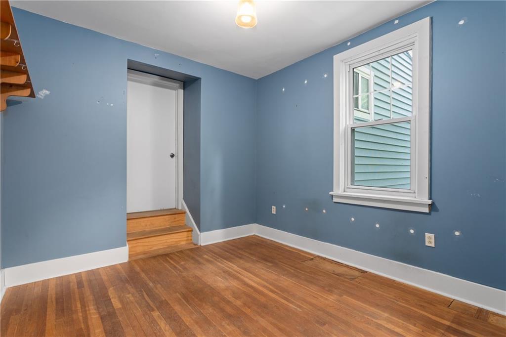 9 Woodside Road Pittsburgh, PA 15221 - Photo 11 of 24 a view of empty room with wooden floor and fan