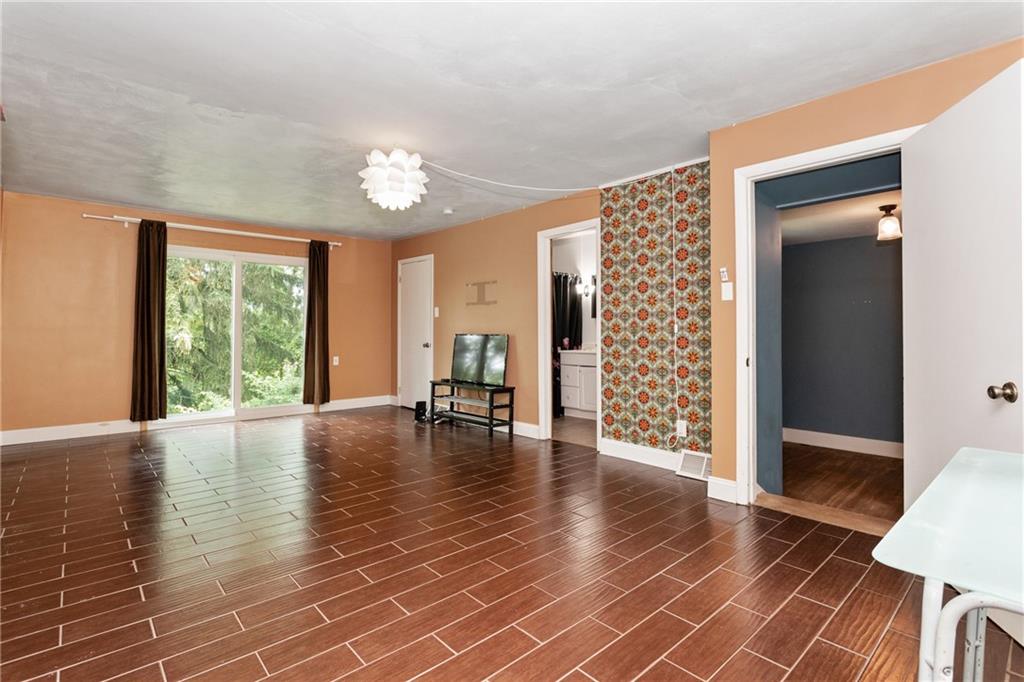 9 Woodside Road Pittsburgh, PA 15221 - Photo 12 of 24 a view of an empty room with window and wooden floor