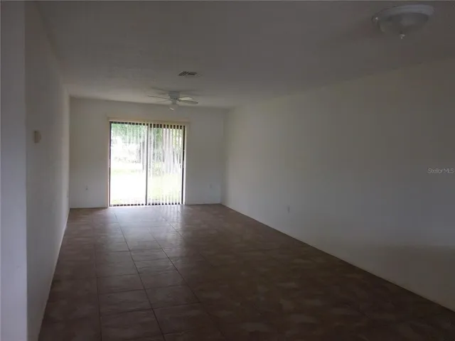 an empty room with windows and entrance