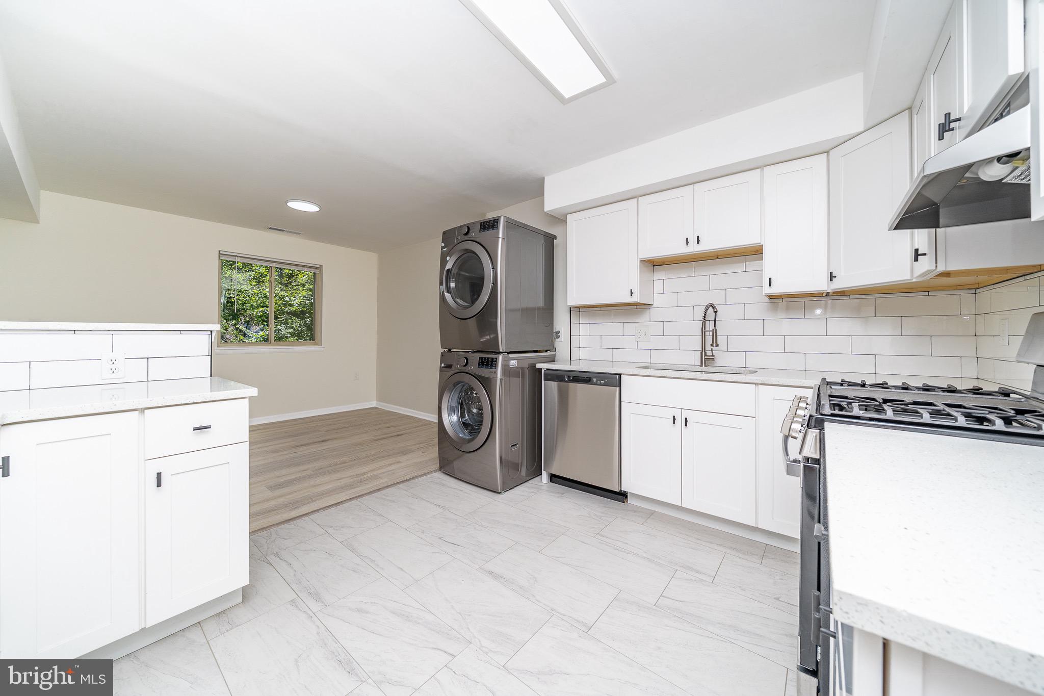 9910 Walker House Road, Unit 99104 Gaithersburg, MD 20886 - Photo 13 of 32 a kitchen with a cabinets and appliances