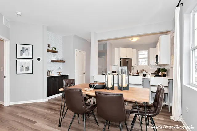 a dining room with furniture and wooden floor