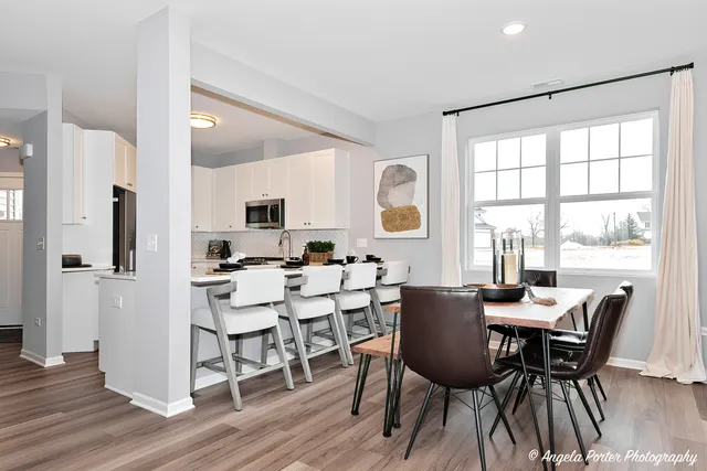 a view of a dining room with furniture and window
