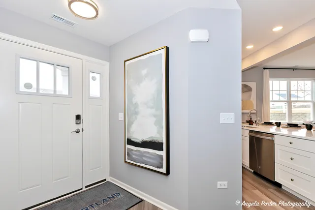 a view of a bathroom with a sink a mirror and a window