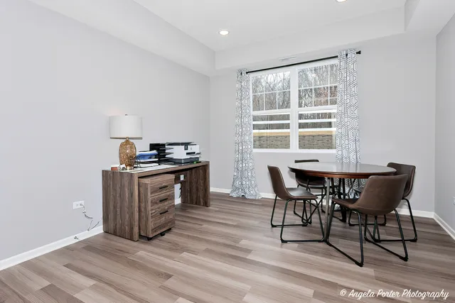 a kitchen with granite countertop white cabinets and wooden floor