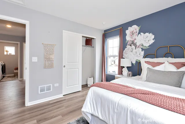 a bedroom with bed and wooden floor