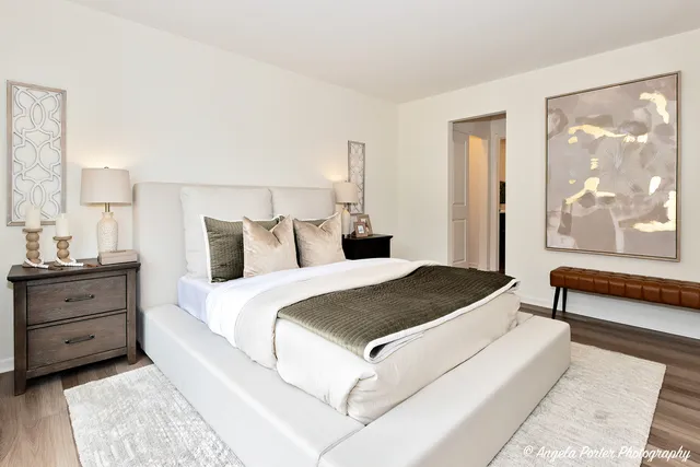 a bedroom with a large bed and a window