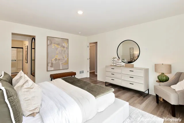 a bedroom with a bed and a dresser