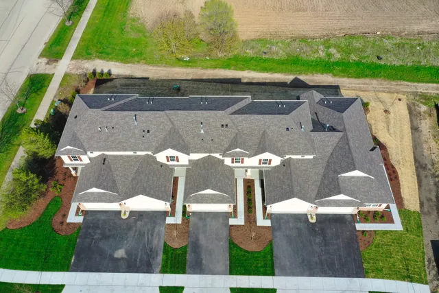 an aerial view of a backyard with chairs