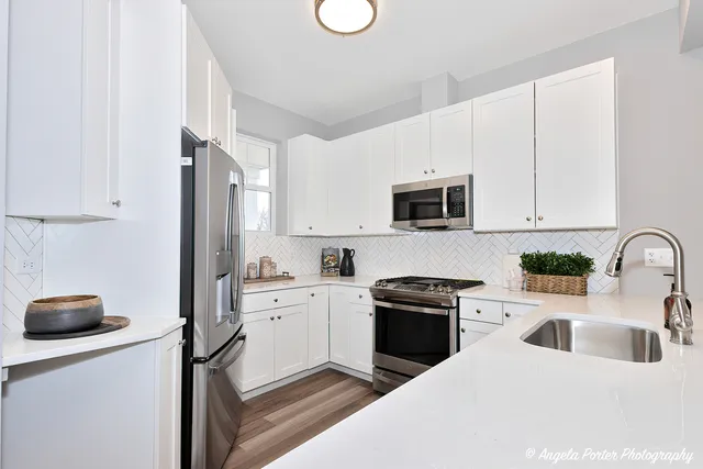 a kitchen with a sink a stove and refrigerator