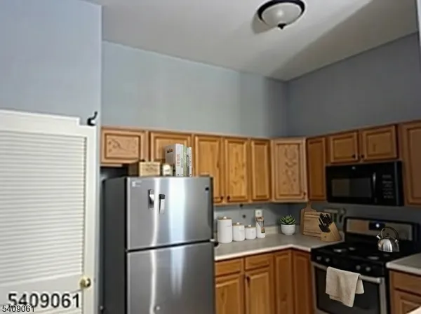 a kitchen with stainless steel appliances granite countertop a refrigerator sink and cabinets