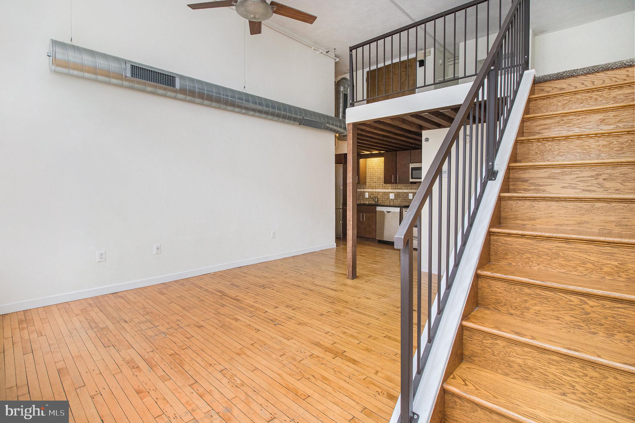 1201 Fitzwater Street, Unit 207 Philadelphia, PA 19147 - Photo 12 of 39 a view of a hallway with wooden floor and staircase