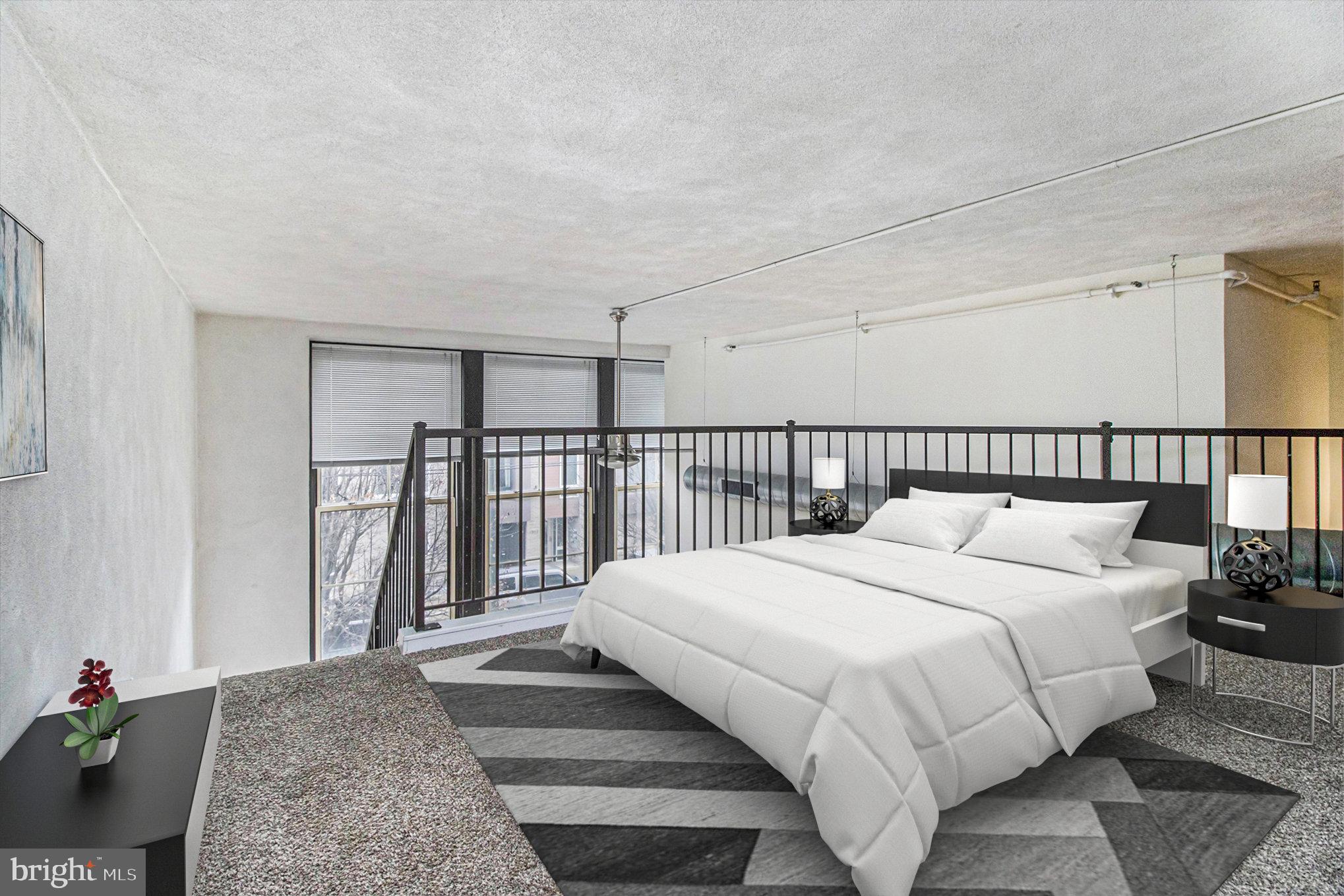 1201 Fitzwater Street, Unit 207 Philadelphia, PA 19147 - Photo 14 of 39 a large bed sitting in a bedroom next to a lamp