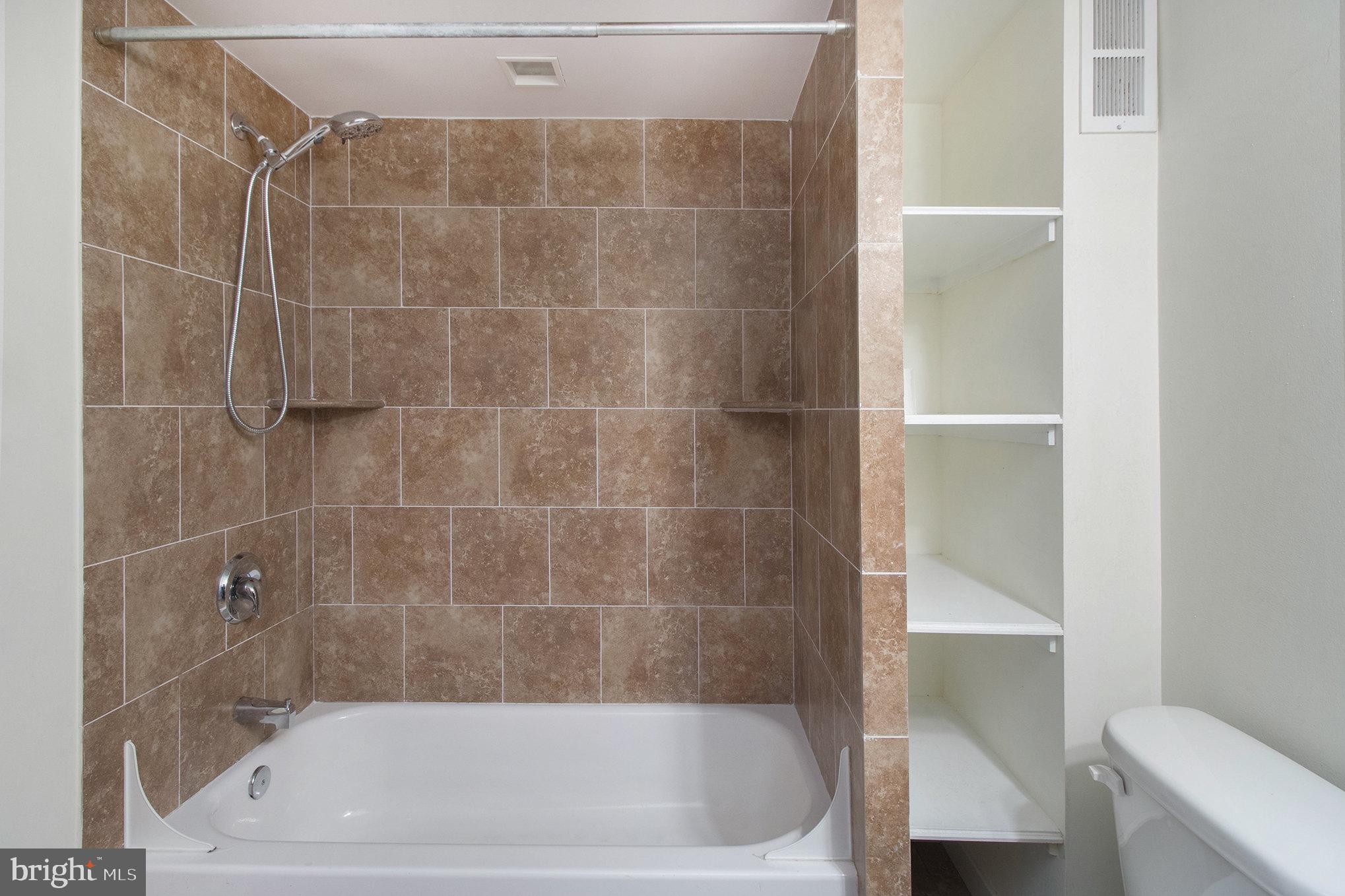 1201 Fitzwater Street, Unit 207 Philadelphia, PA 19147 - Photo 22 of 39 a bath tub sitting next to a white toilet