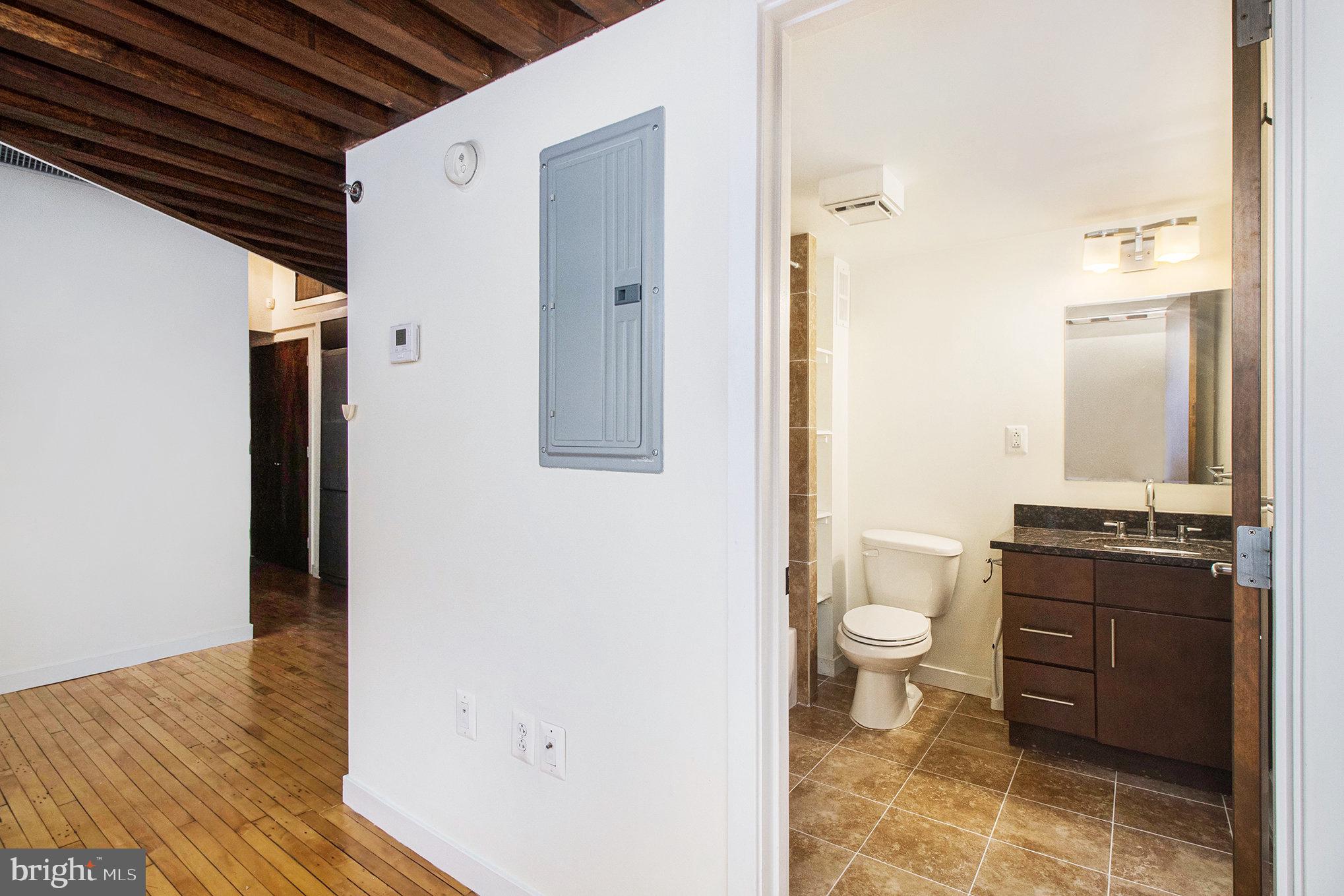1201 Fitzwater Street, Unit 207 Philadelphia, PA 19147 - Photo 23 of 39 a bathroom with a granite countertop sink toilet and shower