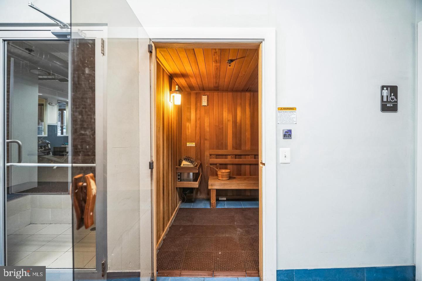 1201 Fitzwater Street, Unit 207 Philadelphia, PA 19147 - Photo 6 of 39 a view of a hallway with wooden floor and a living room