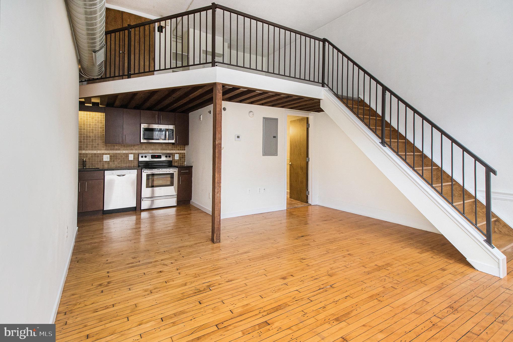 1201 Fitzwater Street, Unit 207 Philadelphia, PA 19147 - Photo 9 of 39 a view of a hallway with wooden floor and staircase