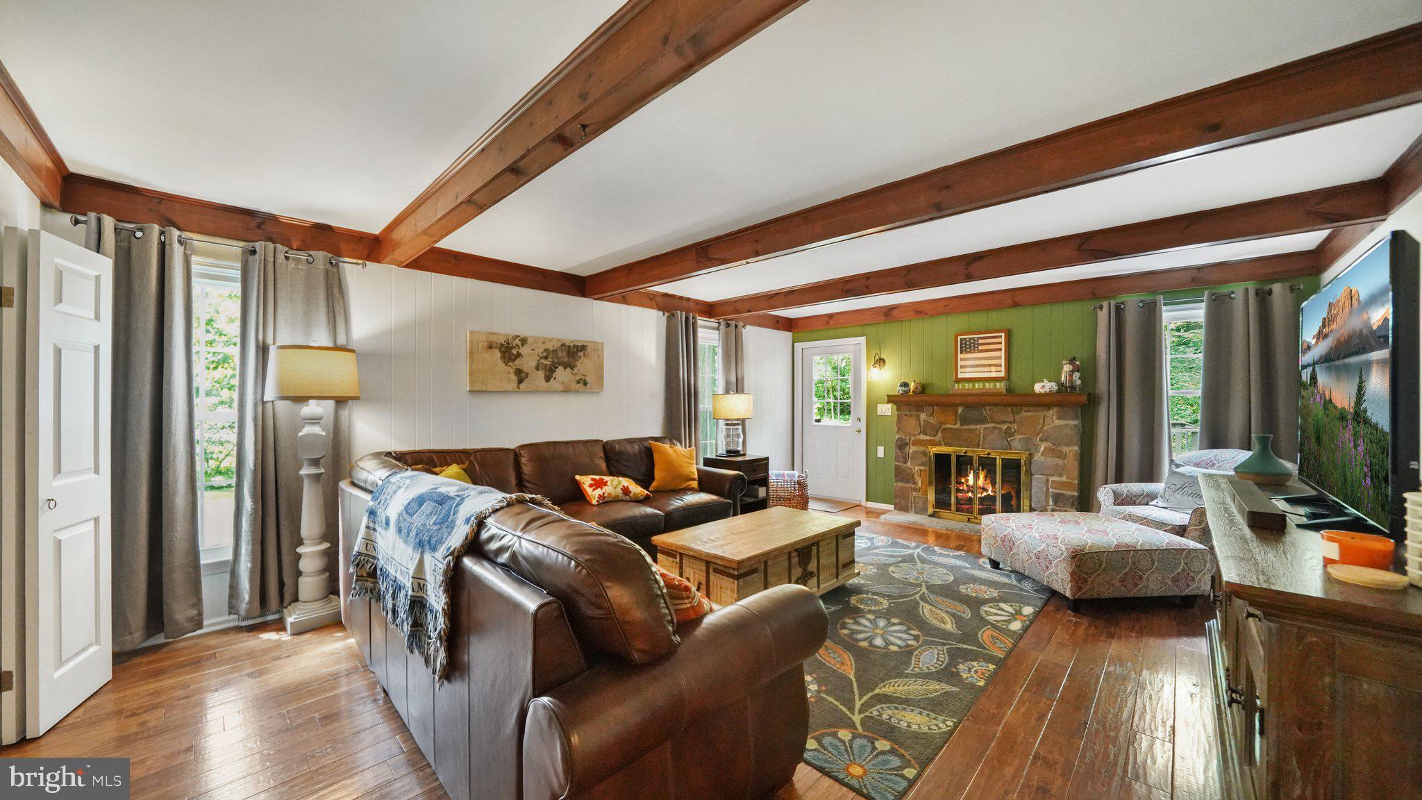 2 James Thomas Road Malvern, PA 19355 - Photo 22 of 40 Family room features wood floor & stone fireplace