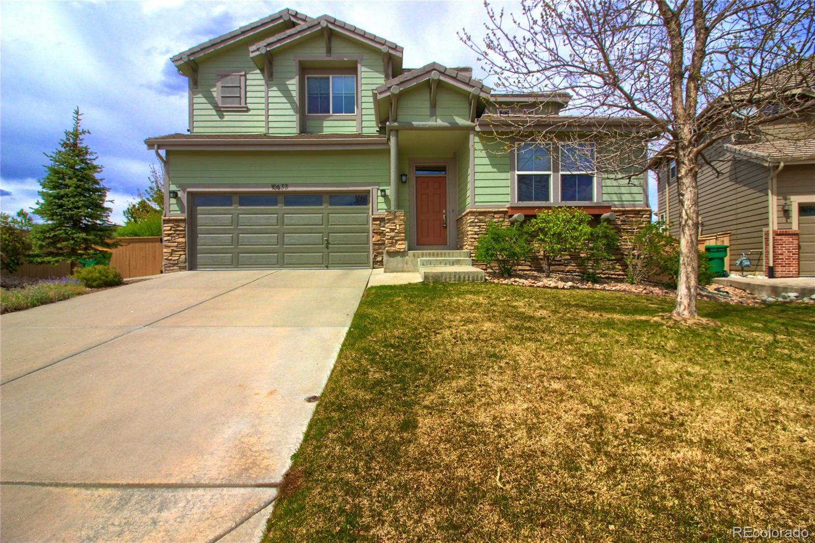 10677 Wynspire Road Highlands Ranch, CO 80130 - Photo 1 of 40 a front view of a house with garden