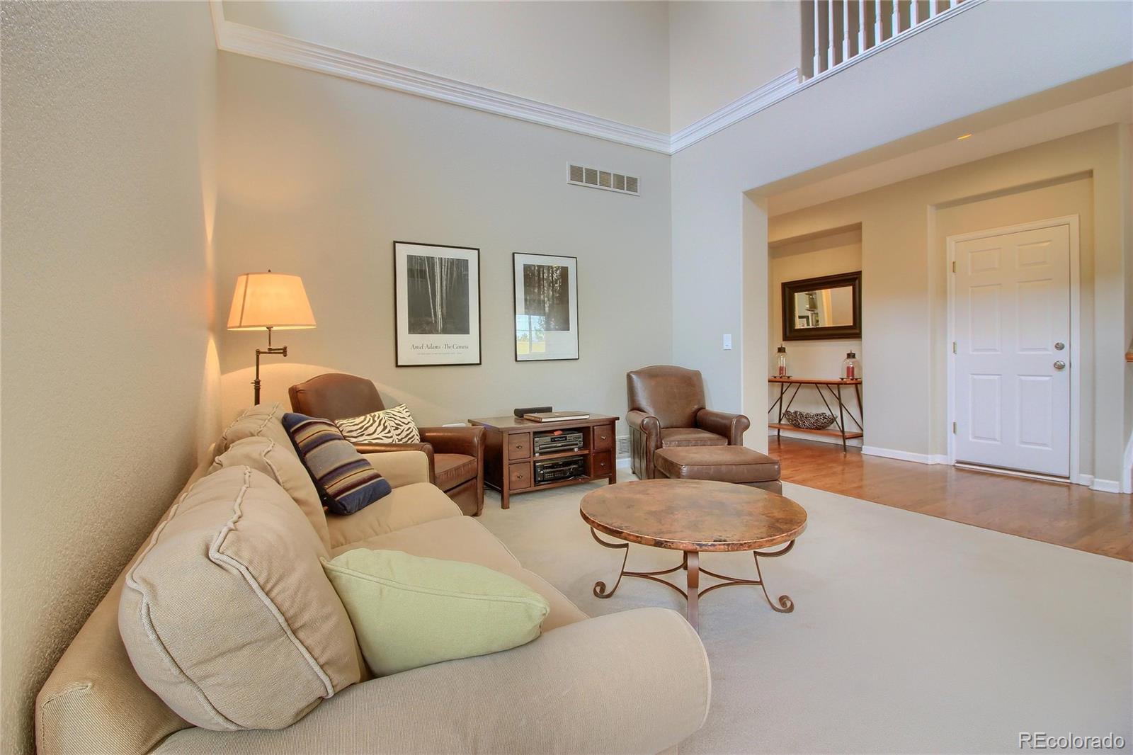 10677 Wynspire Road Highlands Ranch, CO 80130 - Photo 14 of 40 a living room with furniture and a lamp