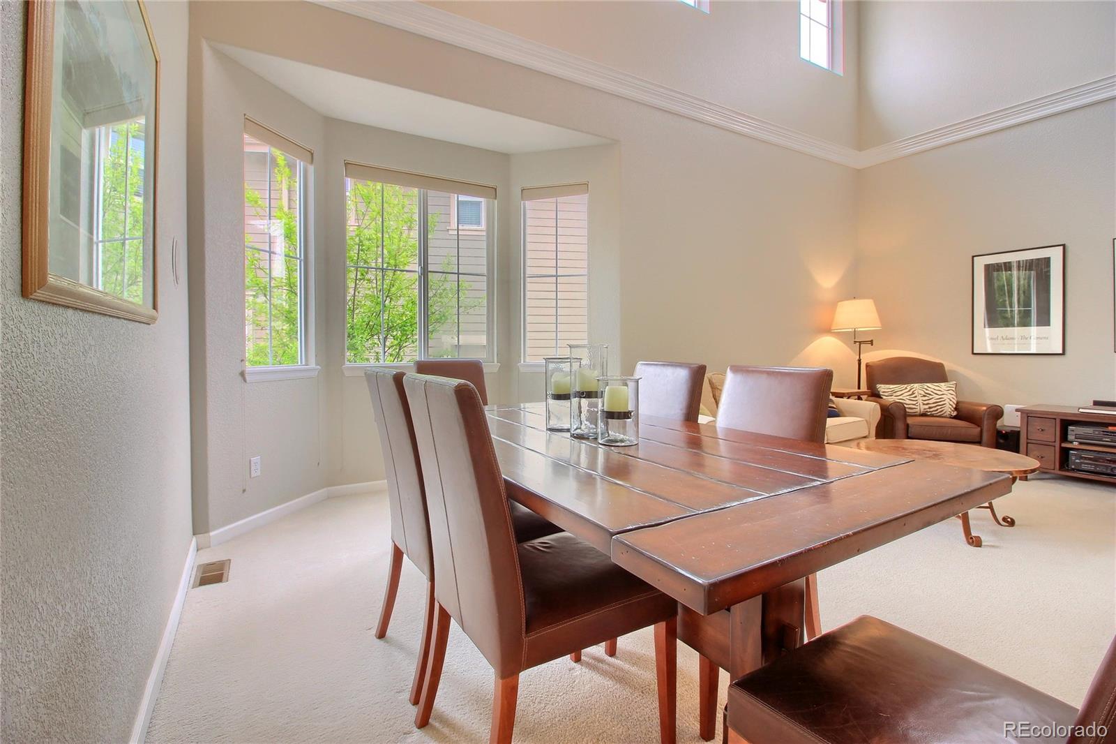 10677 Wynspire Road Highlands Ranch, CO 80130 - Photo 19 of 40 a view of a dining room with furniture and a window