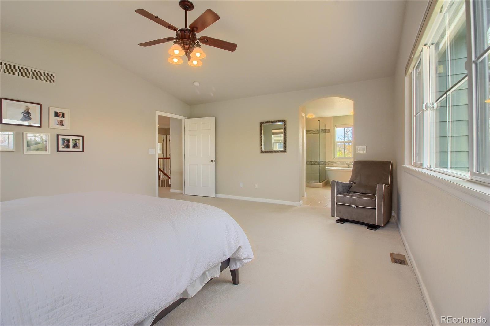 10677 Wynspire Road Highlands Ranch, CO 80130 - Photo 22 of 40 a bedroom with a bed and furniture