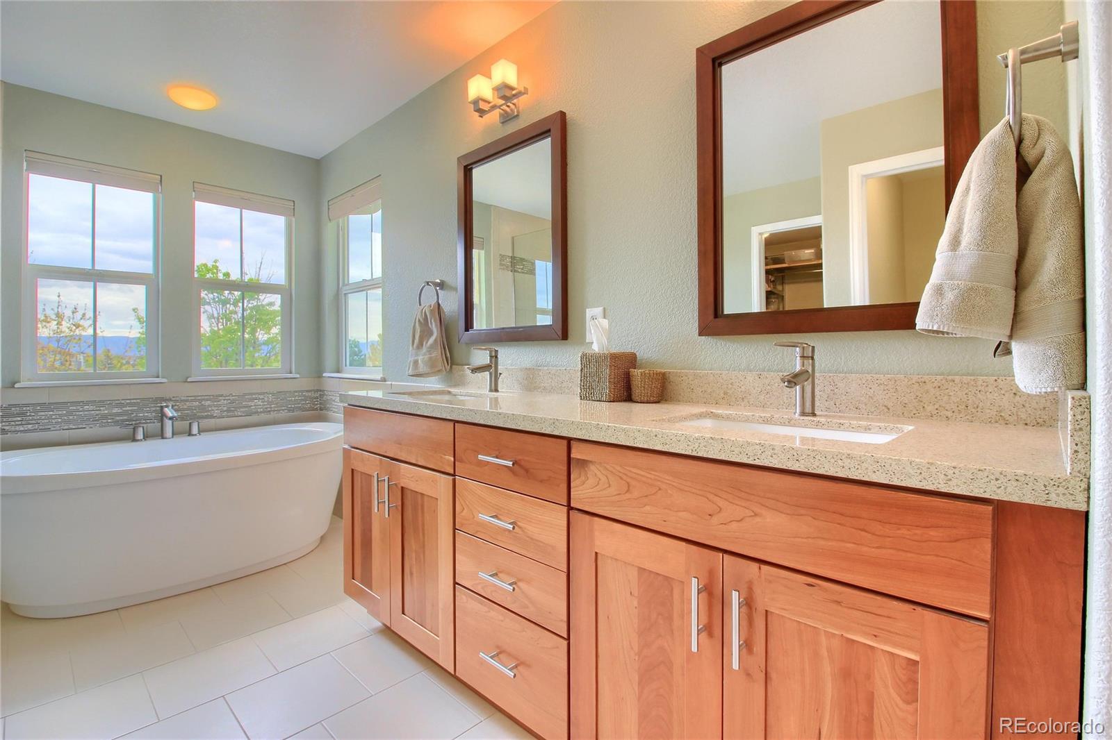 10677 Wynspire Road Highlands Ranch, CO 80130 - Photo 24 of 40 a bathroom with a granite countertop sink and a bathtub