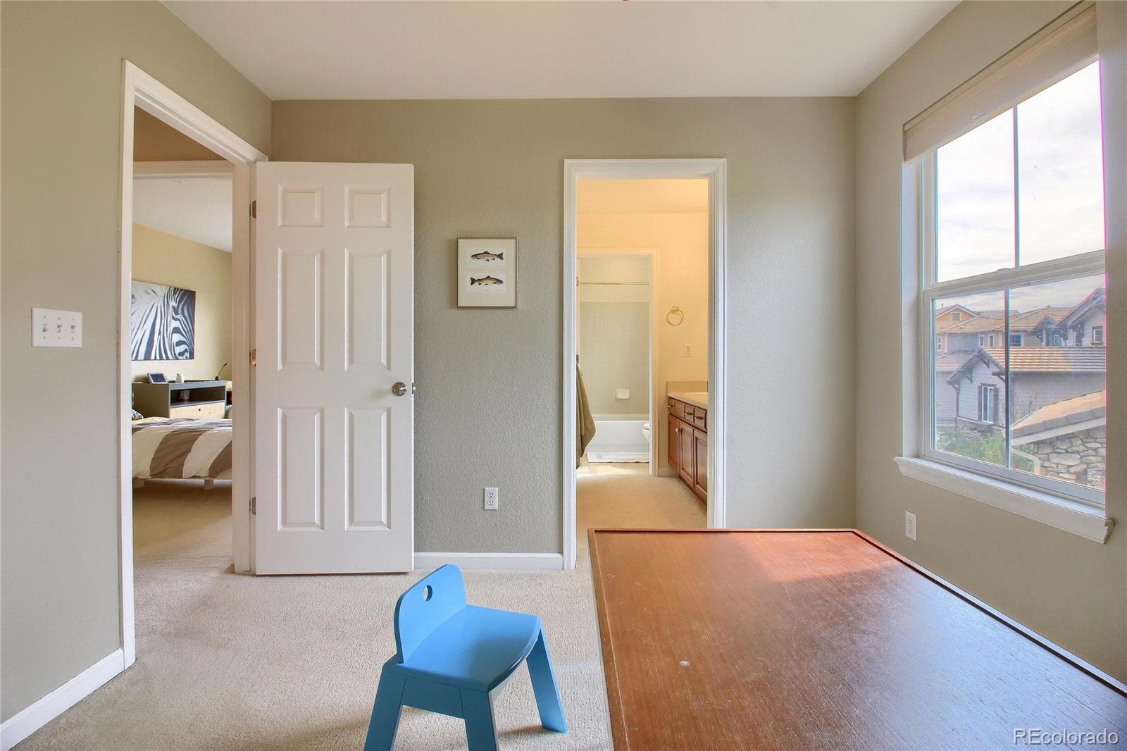 10677 Wynspire Road Highlands Ranch, CO 80130 - Photo 29 of 40 a view of room with furniture and a large window