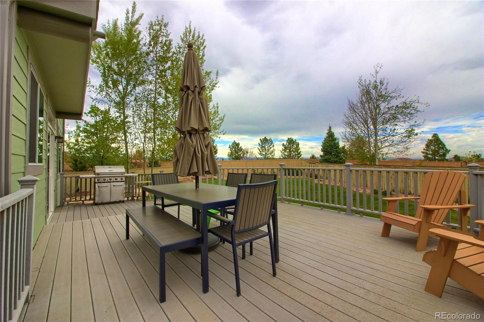 10677 Wynspire Road Highlands Ranch, CO 80130 - Photo 3 of 40 a view of balcony with outdoor seating and wooden floor